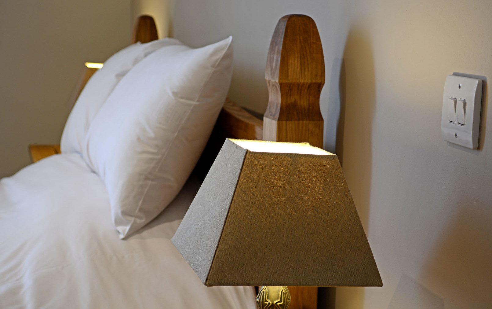 Bedside table lamp adjacent to a bed